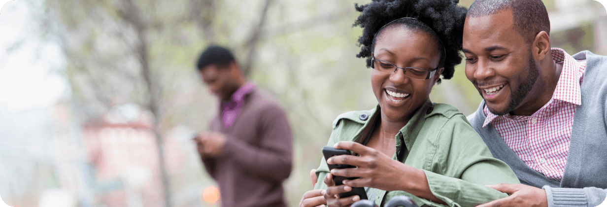 Two people looking at a payment on a phone together