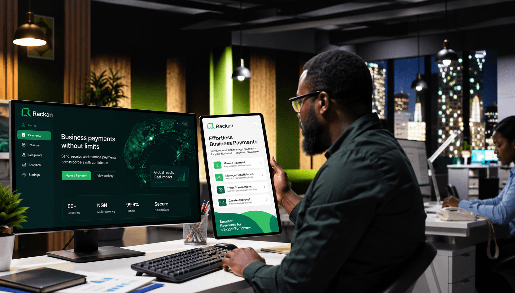 A Rackan customer reviewing the payments dashboard on a monitor and tablet