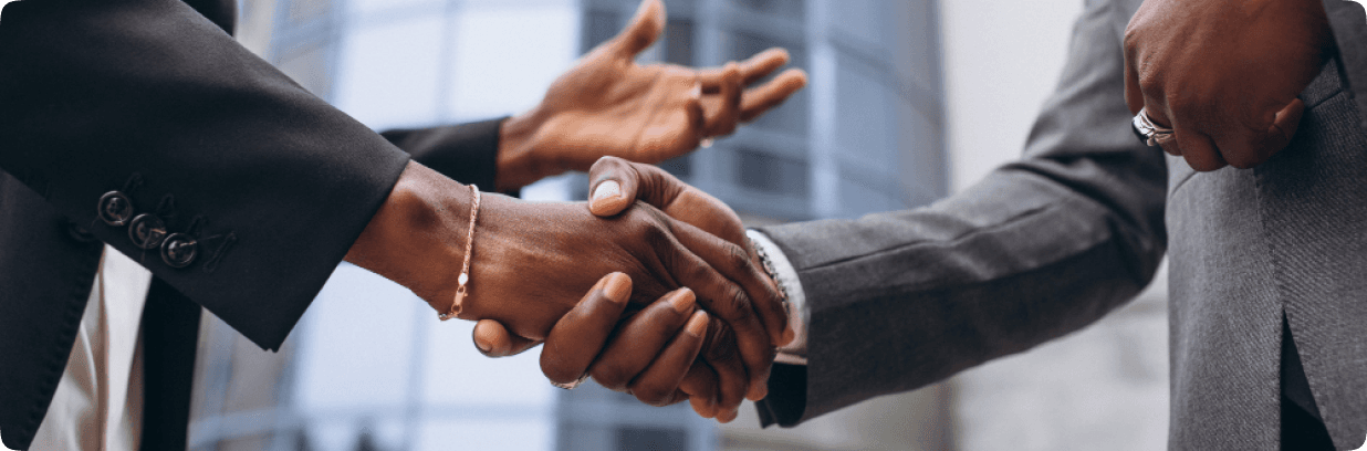 Two people in suits shaking hands